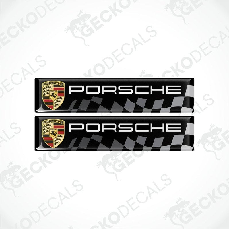 Two black, silver, and red checkered vinyl decals with the Porsche logo