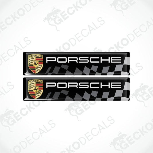 Two black, silver, and red checkered vinyl decals with the Porsche logo