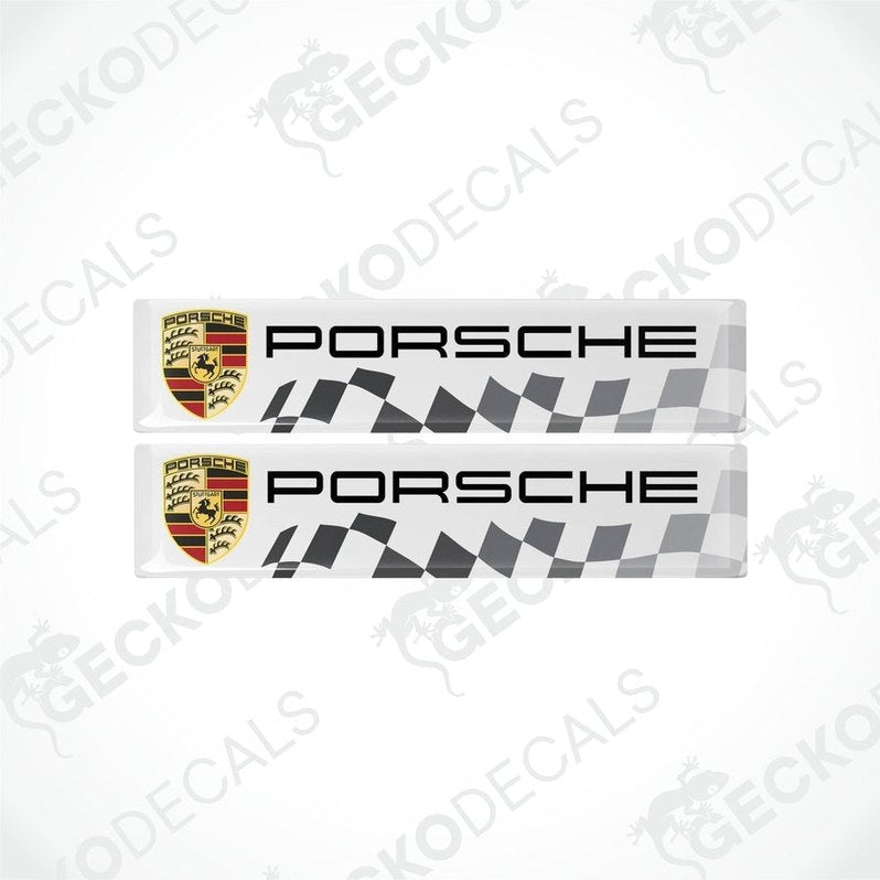 Two withe, silver, and red checkered vinyl decals with the Porsche logo