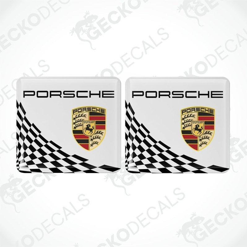 Two white,black and gold Porsche branded vinyl stickers with a checkered pattern.
