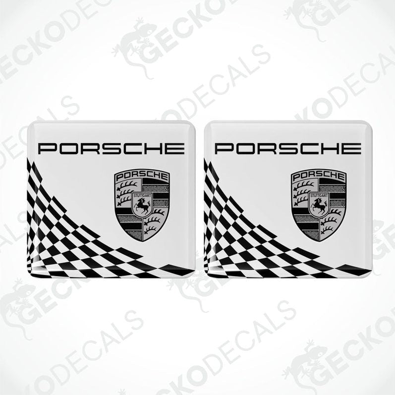 Two white,black and gold Porsche branded vinyl stickers with a checkered pattern.