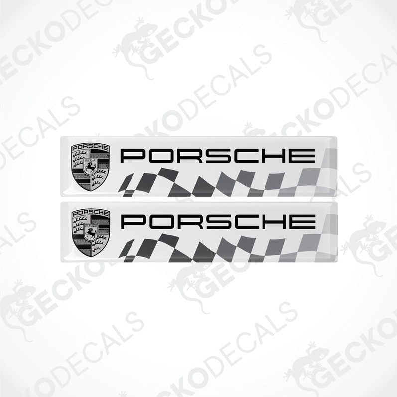 Two withe vinyl stickers with the Porsche racing logo and a checkered pattern.