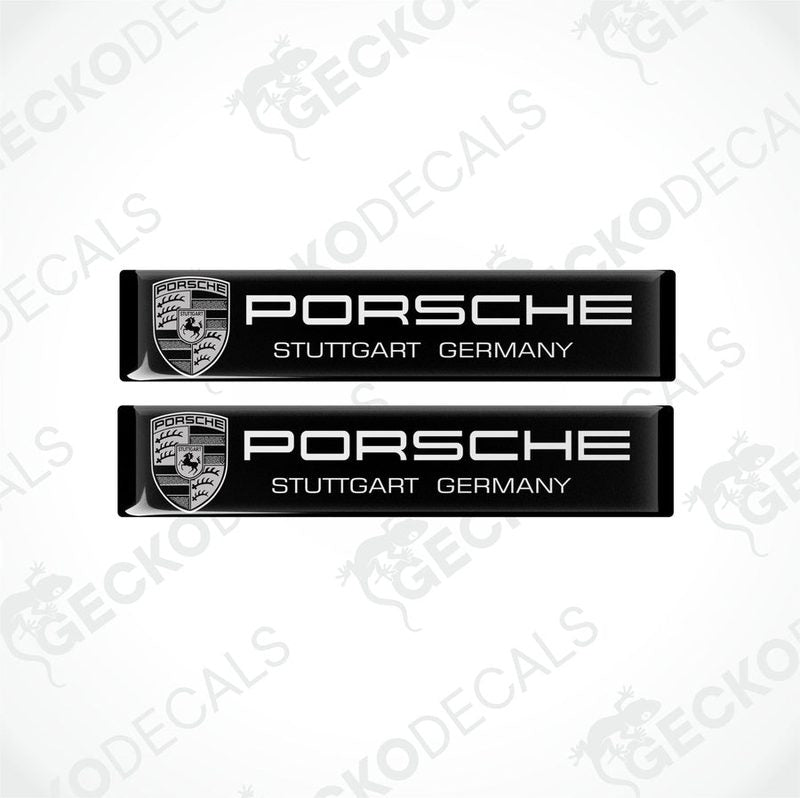 Two black rectangular vinyl decals with the text 'PORSCHE STUTTGART GERMANY' on them, placed on a white background.