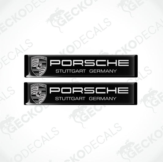 Two black rectangular vinyl decals with the text 'PORSCHE STUTTGART GERMANY' on them, placed on a white background.