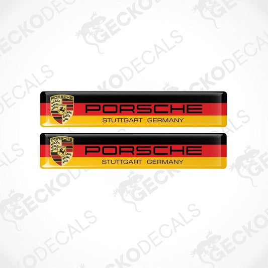 Two rectangular car decals with the Porsche Stuttgart Germany text and the Porsche logo, predominantly in red, yellow, black, and white colors.