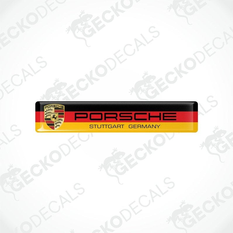 Two rectangular car decals with the Porsche Stuttgart Germany text and the Porsche logo, predominantly in red, yellow, black, and white colors.