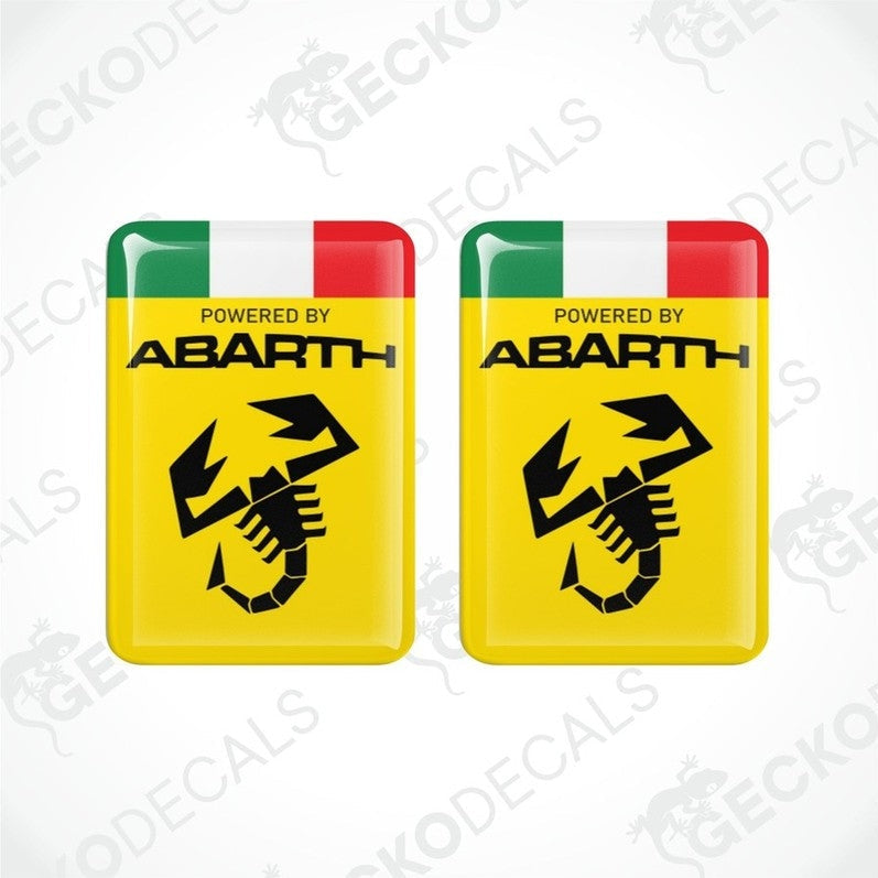 Two yellow vinyl stickers with 'POWERED BY ABARTH' text and a graphic of a black and white checkered flag with a red and green stripe on top. Gecko Decals branding is visible on the stickers.