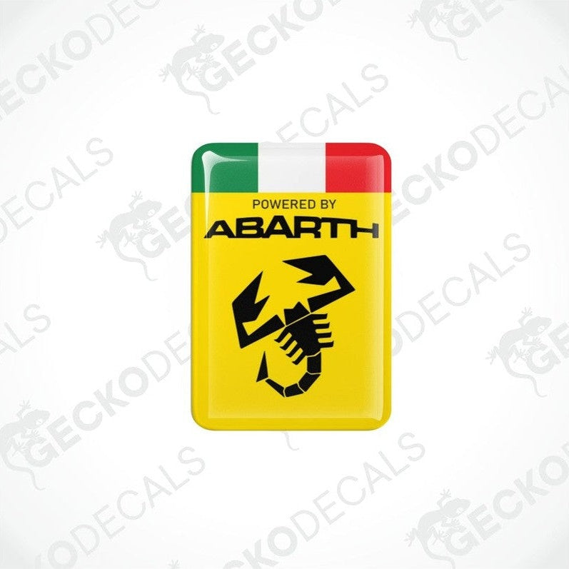 Two yellow vinyl stickers with 'POWERED BY ABARTH' text and a graphic of a black and white checkered flag with a red and green stripe on top. Gecko Decals branding is visible on the stickers.