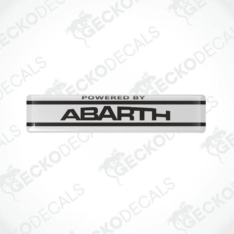  White vinyl stickers with the text 'POWERED BY ABARTH' and a logo depicting a stylized 'A' in black on a white background, placed against a white background with 'GECKODECALS' and 'ABARTH' logos.