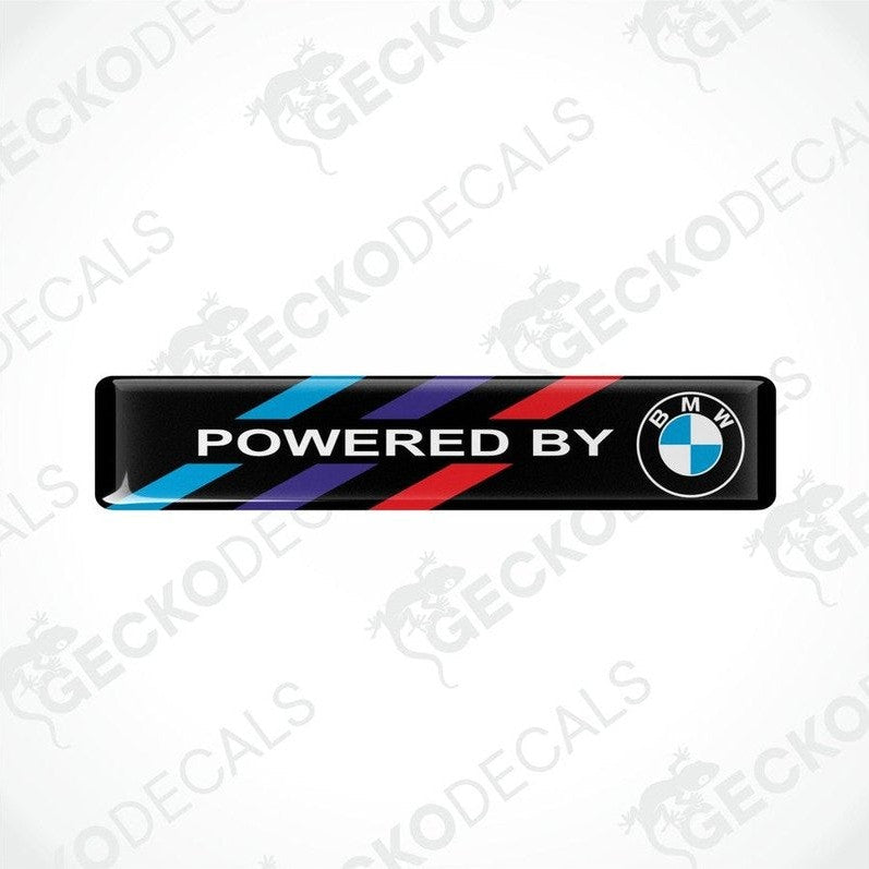 Vinyl stickers with 'POWERED BY BMW' text and a colorful stripe pattern on a black background.