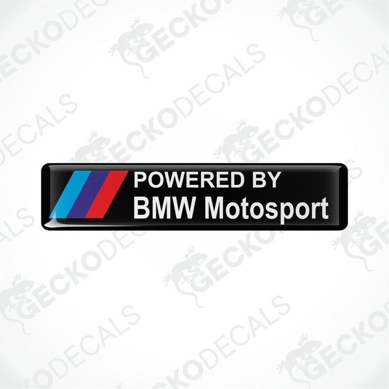Black vinyl stickers with the text 'POWERED BY BMW MOTOSPORT' and the BMW logo in red, white, and purple.