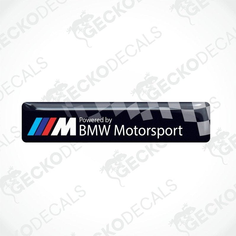  Vinyl stickers with a  POWERED BY BMW M MOTORSPORT  logo, predominantly black with blue and red checkered pattern.