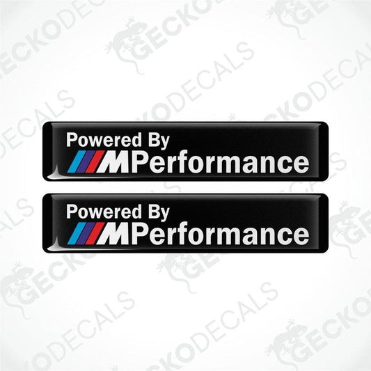 Two black vinyl stickers with the text 'POWERED BY M PERFORMANCE' and the BMW logo.