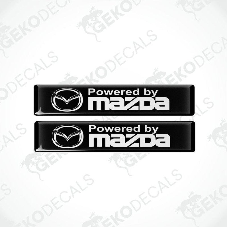 Two black vinyl stickers with the Powered by MAZDA logo in white.