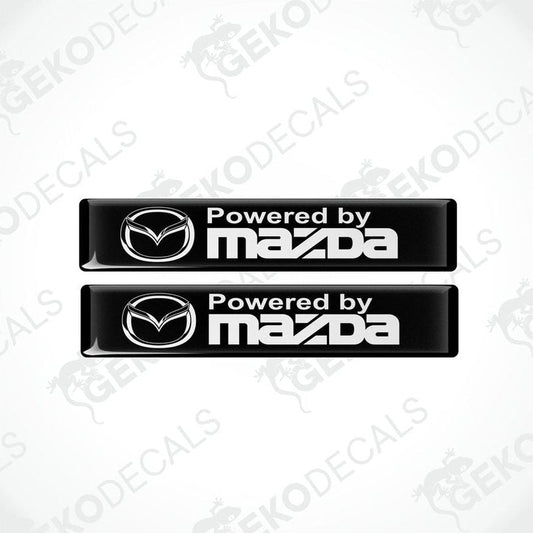Two black vinyl stickers with the Powered by MAZDA logo in white.