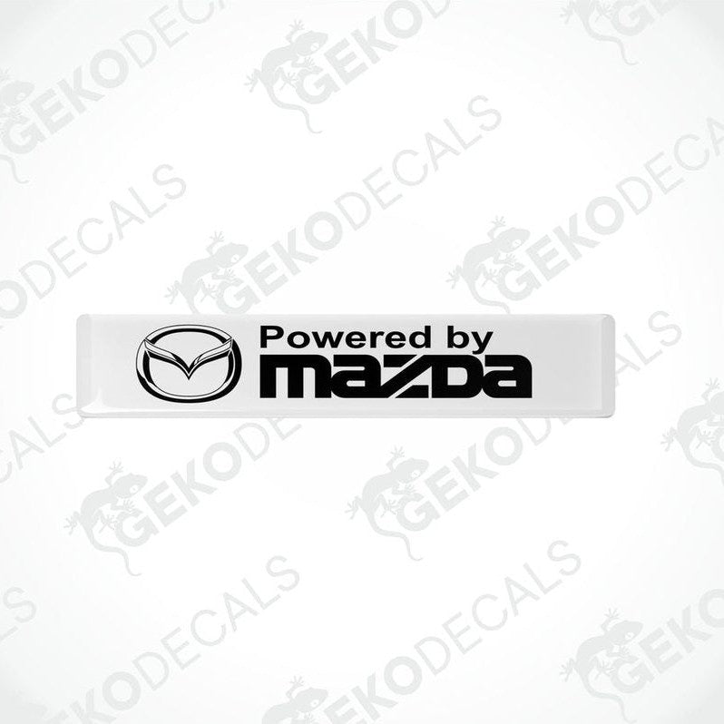 White vinyl stickers with the Powered by MAZDA logo in black.