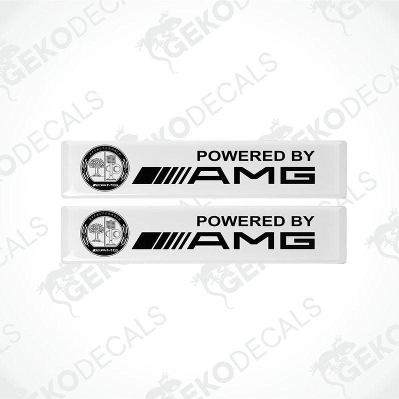 Two white vinyl decals with the text 'POWERED BY AMG' and the AMG logo.