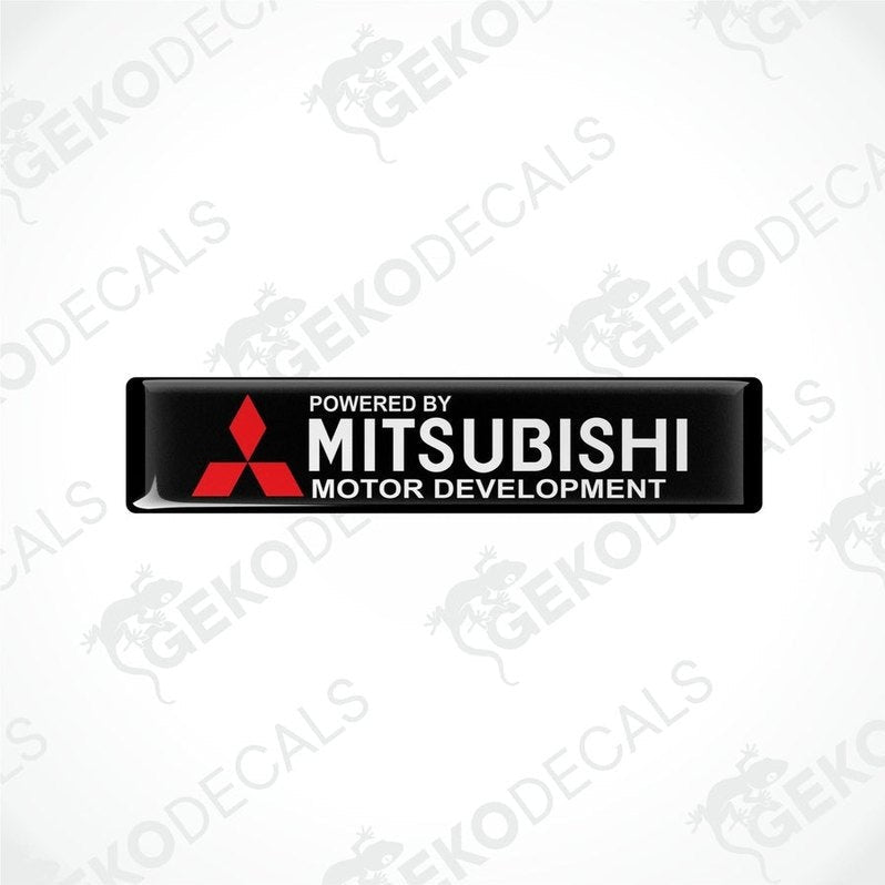  Rectangular black vinyl decals with the red Mitsubishi logo and the text 'POWERED BY MITSUBISHI MOTOR DEVELOPMENT'.