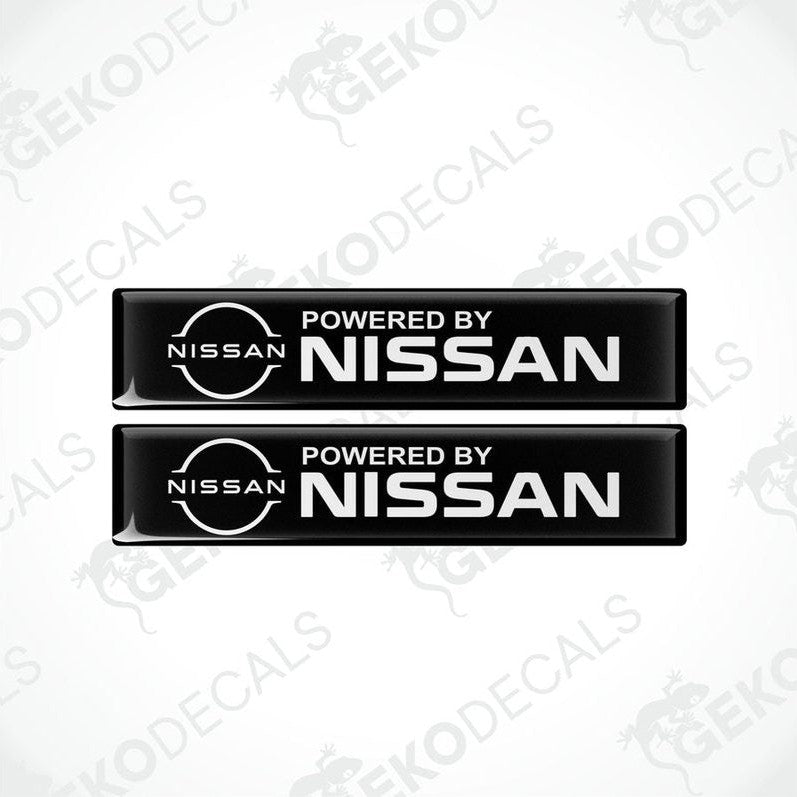 Two black vinyl stickers with 'Powered by NISSAN' text and a white circular logo of NISSAN in the center.