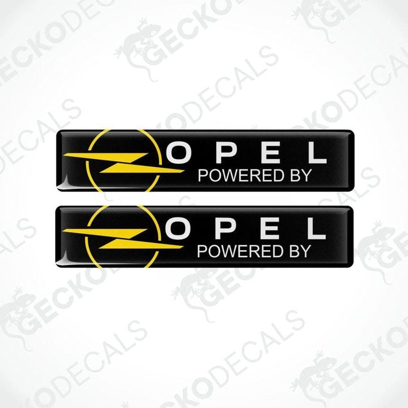 Two Opel logo stickers with 'Powered by' text on a white background.