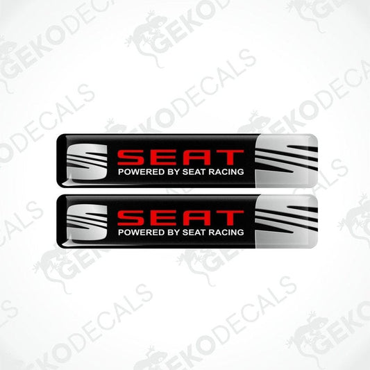 Two rectangular vinyl decals with a polyurethane coating, featuring the text 'SEAT POWERED BY SEAT RACING' in a black, red, and white color scheme.