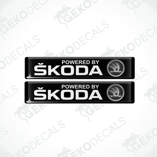 Two black decals with white text and the Skoda logo, labeled 'POWERED BY SKODA'.