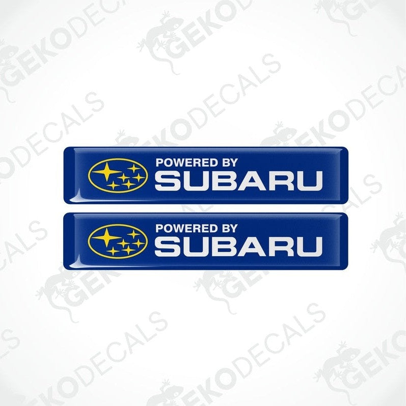 Two blue vinyl stickers with the text 'POWERED BY SUBARU' and the Subaru logo.