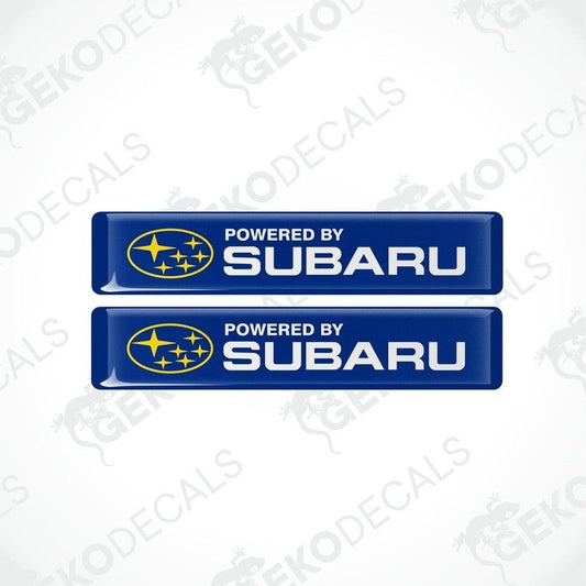 Two blue vinyl stickers with the text 'POWERED BY SUBARU' and the Subaru logo.