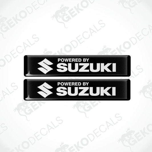 Two black vinyl stickers with the text 'POWERED BY SUZUKI' and the Suzuki logo.