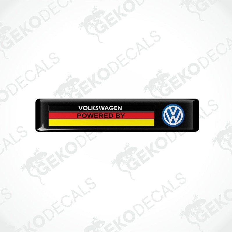  Black vinyl stickers with the text 'Volkswagen POWERED BY' and a flag pattern in red and yellow and a blue logo on a white background.