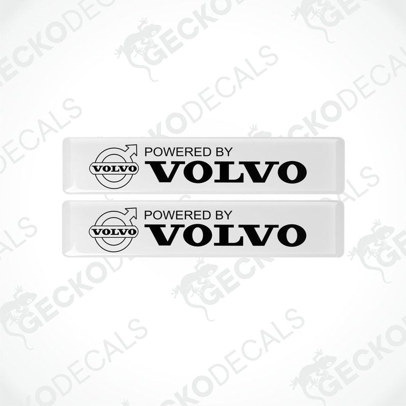 Two withe vinyl stickers with the text 'POWERED BY VOLVO' and a Volvo logo.