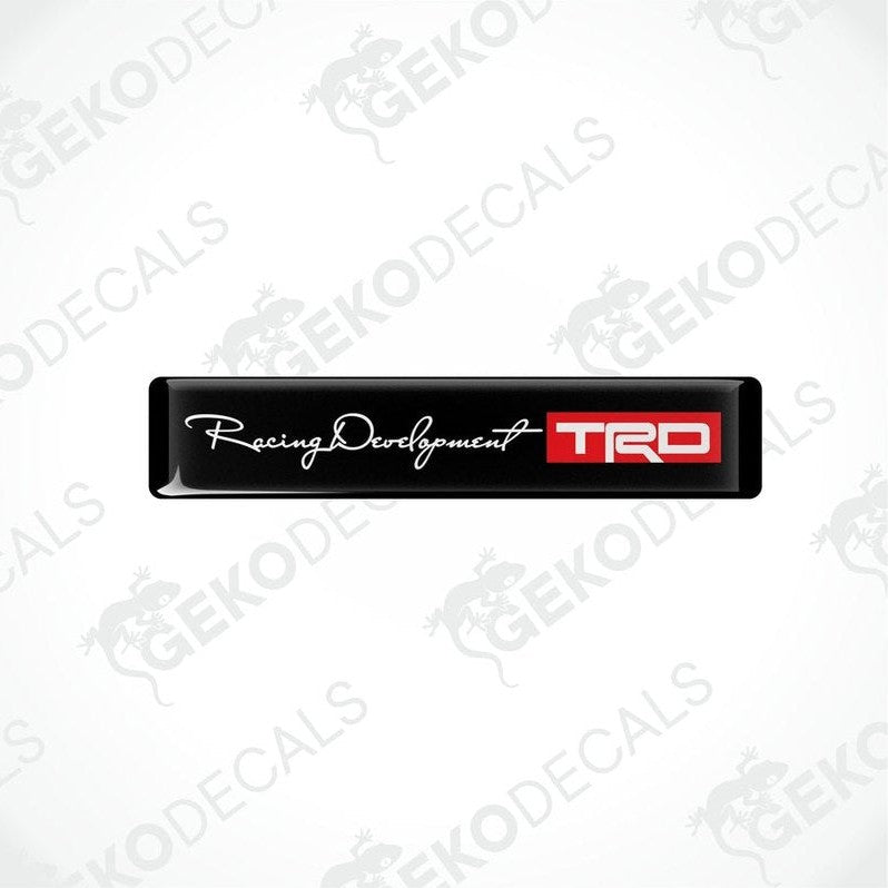 Black vinyl decals with white and red text and logos, one decal reads 'Racing Development' and the other has 'TRD' logo.