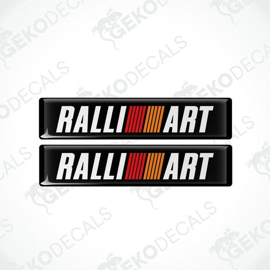 Two rectangular vinyl decals with 'RALLIART' written in white letters and a red and orange stripe design.