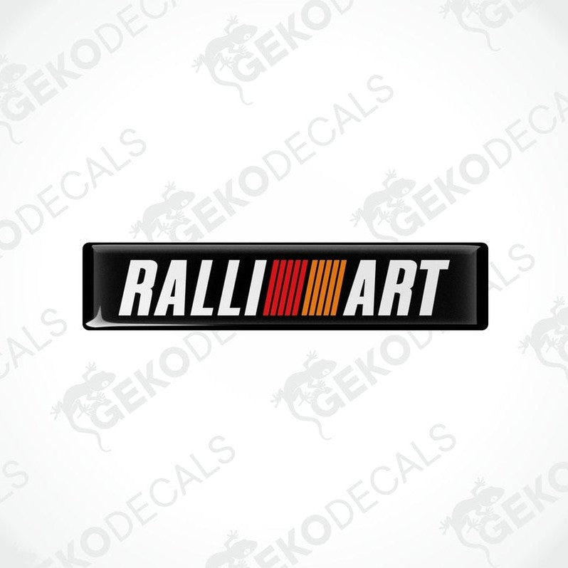  Rectangular vinyl decals with 'RALLIART' written in white letters and a red and orange stripe design.