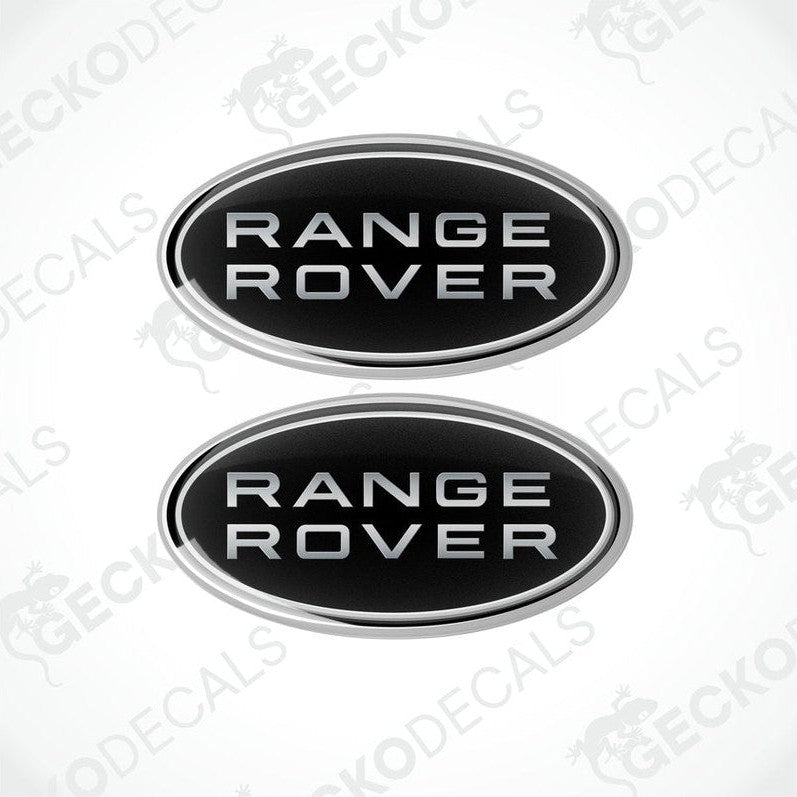Two oval-shaped black car decals with the text 'RANGE ROVER' on them.