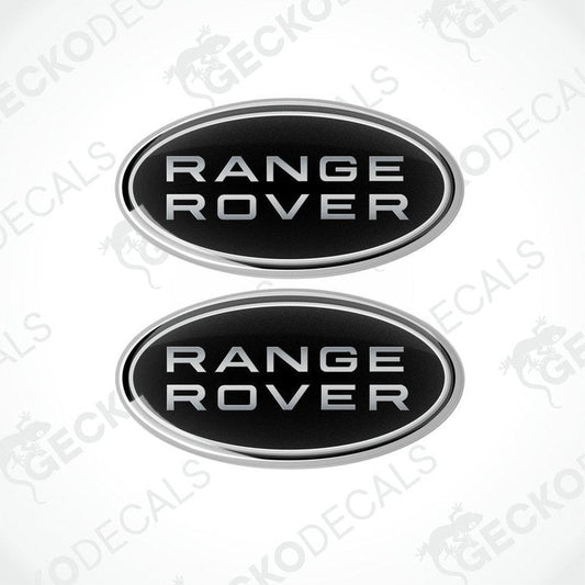 Two oval-shaped black car decals with the text 'RANGE ROVER' on them.