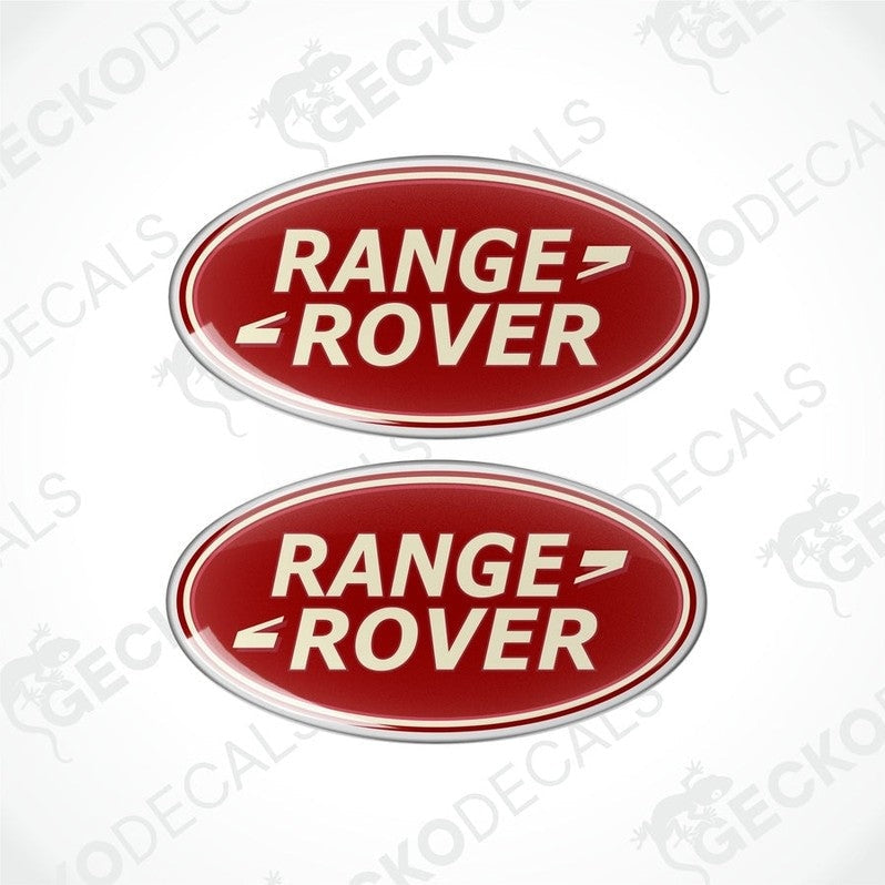Two red and silver oval-shaped vinyl decals with 'RANGE ROVER' text in white.