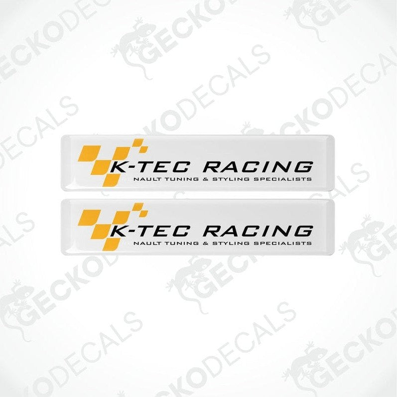 Two withe, yellow, and black racing decals with the text 'K-TEC RACING' and checkered flag design.