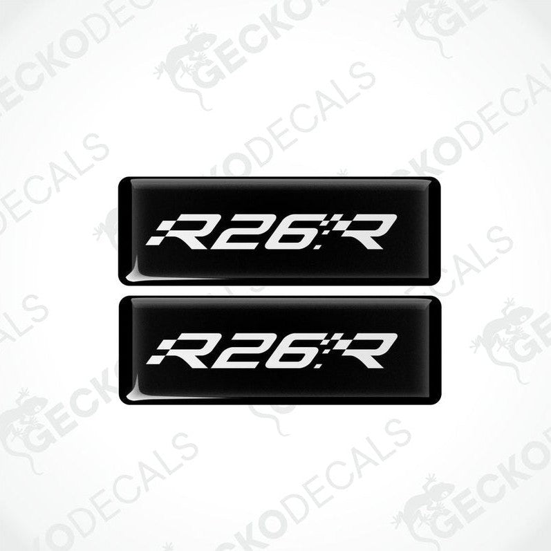 Two black rectangular vinyl decals with 'R26.R' white text on them, intended for use as car stickers.