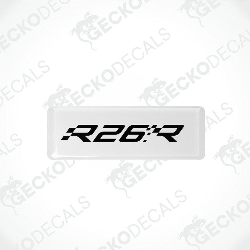 Withe rectangular vinyl decals with 'R26.R' black text on them, intended for use as car stickers.