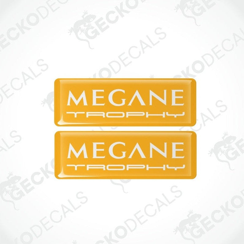 Two yellow rectangular vinyl decals with 'MEGANE TROPHY'withe text on them, intended for use as car stickers.