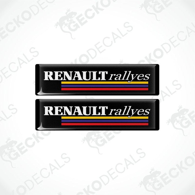 Two black vinyl stickers with the text 'RENAULT RALLYES' and the Renault logo in red, yellow, and blue.