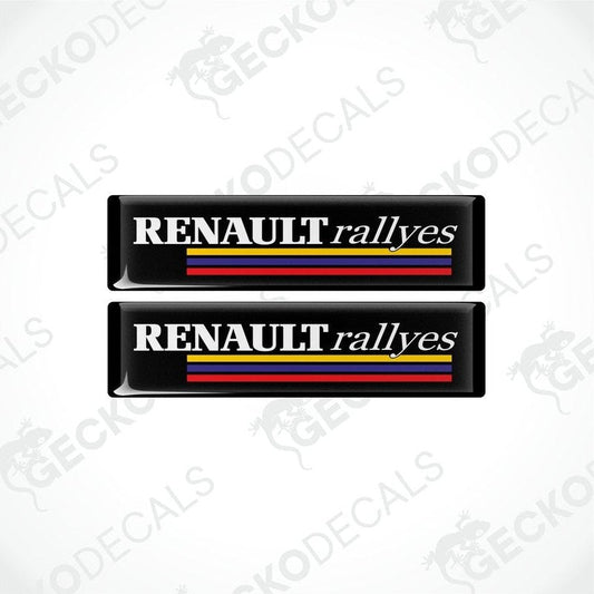 Two black vinyl stickers with the text 'RENAULT RALLYES' and the Renault logo in red, yellow, and blue.