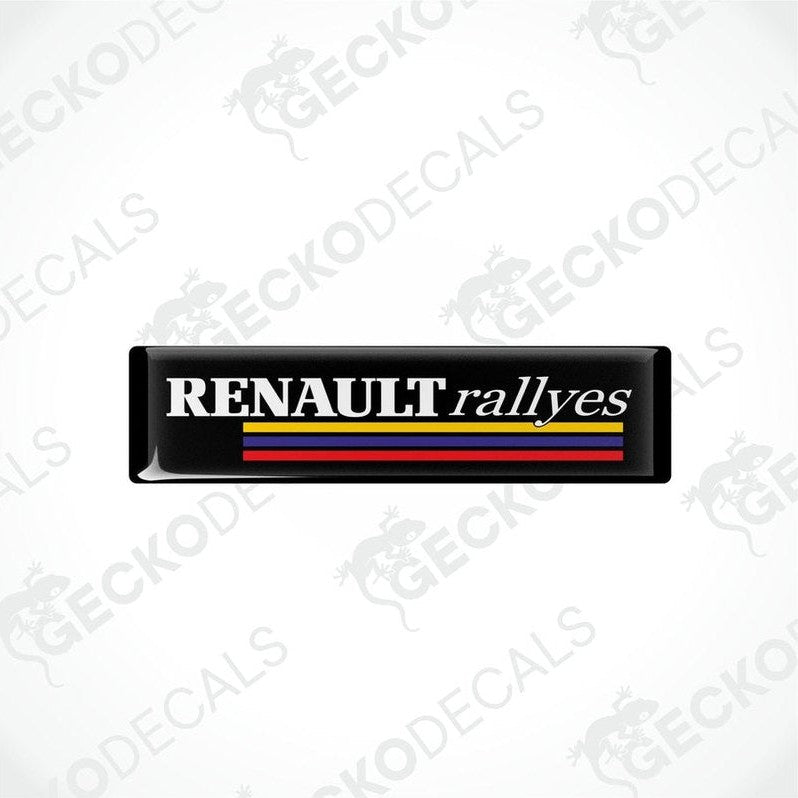 Black vinyl stickers with the text 'RENAULT RALLYES' and the Renault logo in red, yellow, and blue.