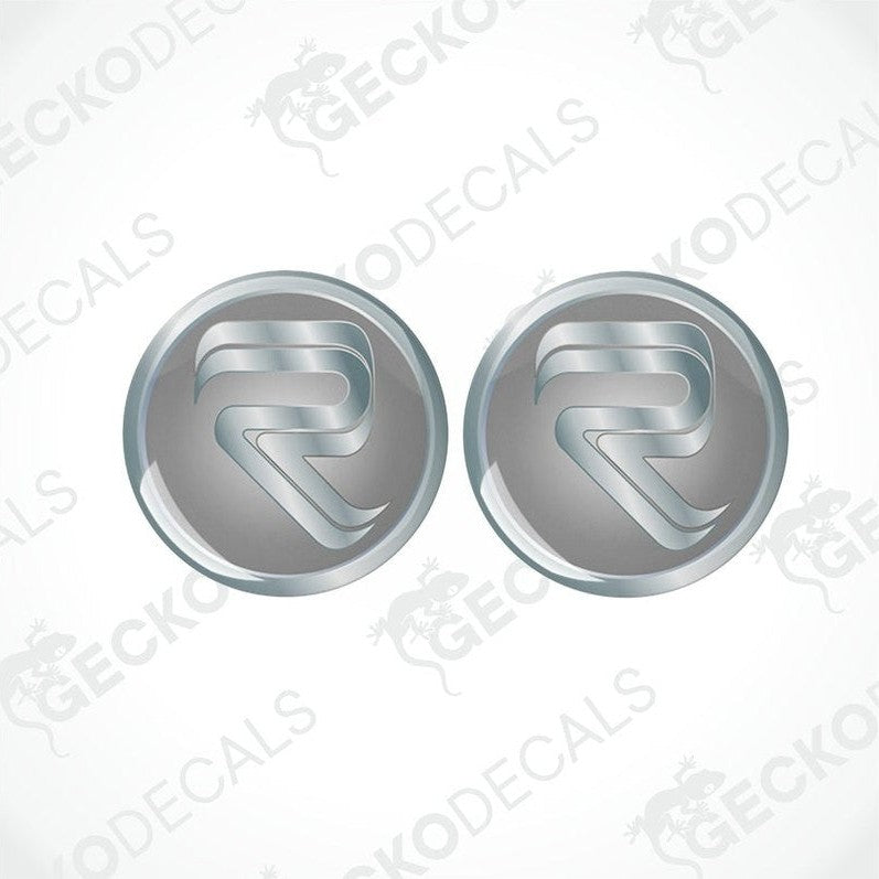 Two round vinyl stickers with a metallic finish and the Rimor logo in the center, placed on a white background with the Gecko Decals logo.