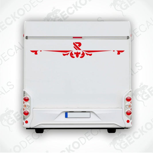 A white caravan with a red and black decal on the rear side, featuring a floral design and the letter 'R' in the center.