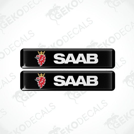 Two black vinyl decals with polyurethane coating featuring the SAAB logo in withe lettering.