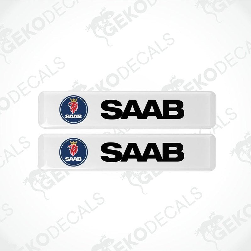 Two withe vinyl decals with polyurethane coating featuring the SAAB logo in black lettering.