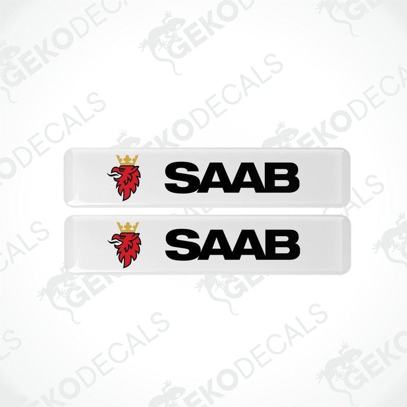 Two withe vinyl decals with polyurethane coating featuring the SAAB logo in black lettering.