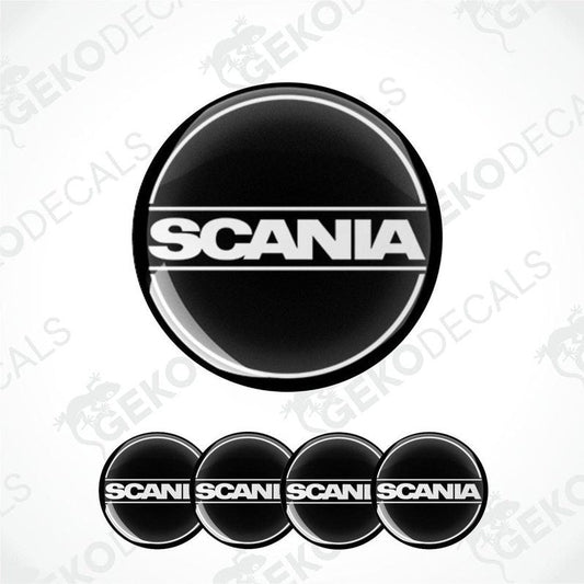 A set of four black, white, and gray vinyl stickers with the word 'SCANIA' printed on them.
